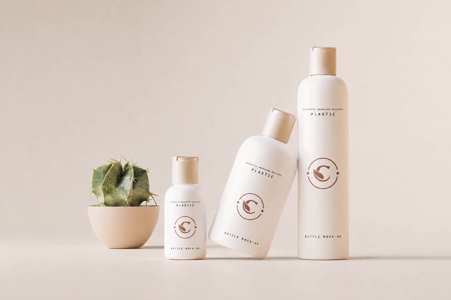 Cream Carisle Naturale bottles lined up by height beside a small potted plant
