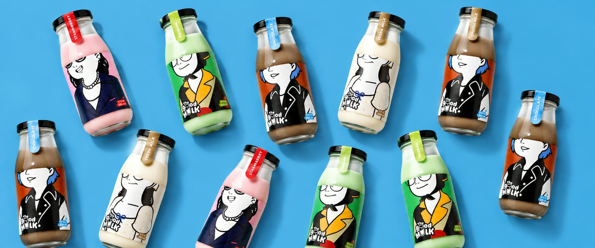 Eleven The Good Milk bottles laid out on a bright blue ground